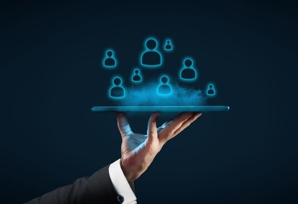 Hand holding a tablet emitting glowing images of diverse individuals, symbolizing the personalized approach of Direct Indexing